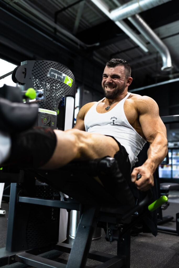 Man using leg extension machine at Cedar Knolls gym