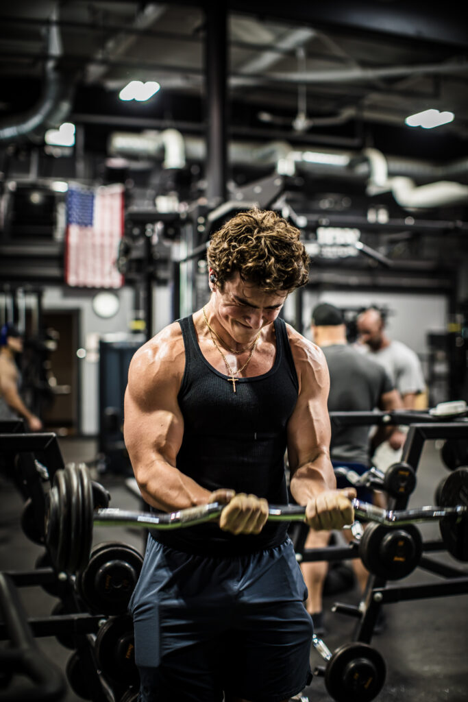 Man doing bicep curls at Cedar Knolls gym